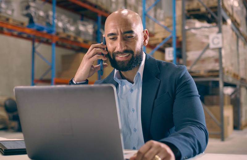 A freight controller on the phone at a desk
