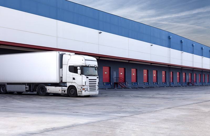 Freight truck reversed onto the loading docks of a large warehouse