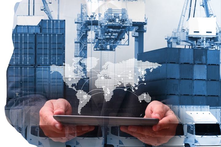 Hands holding a tablet showing a world map over a container terminal